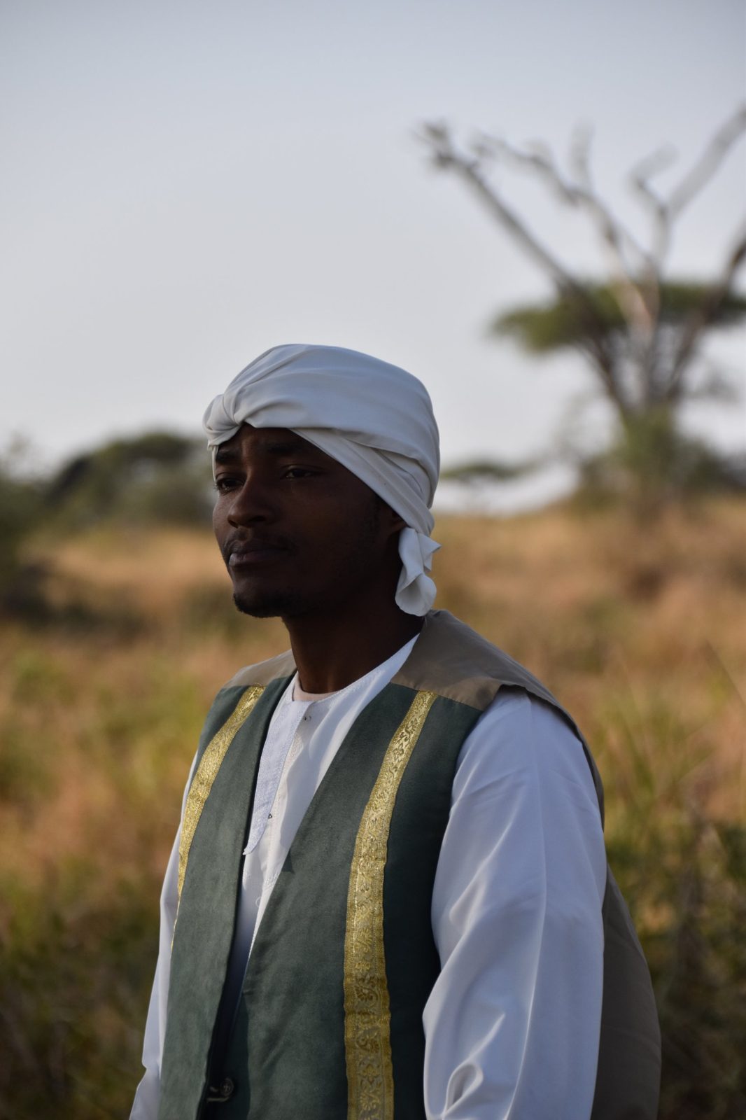 Portrait of a man in a white turban and green vest