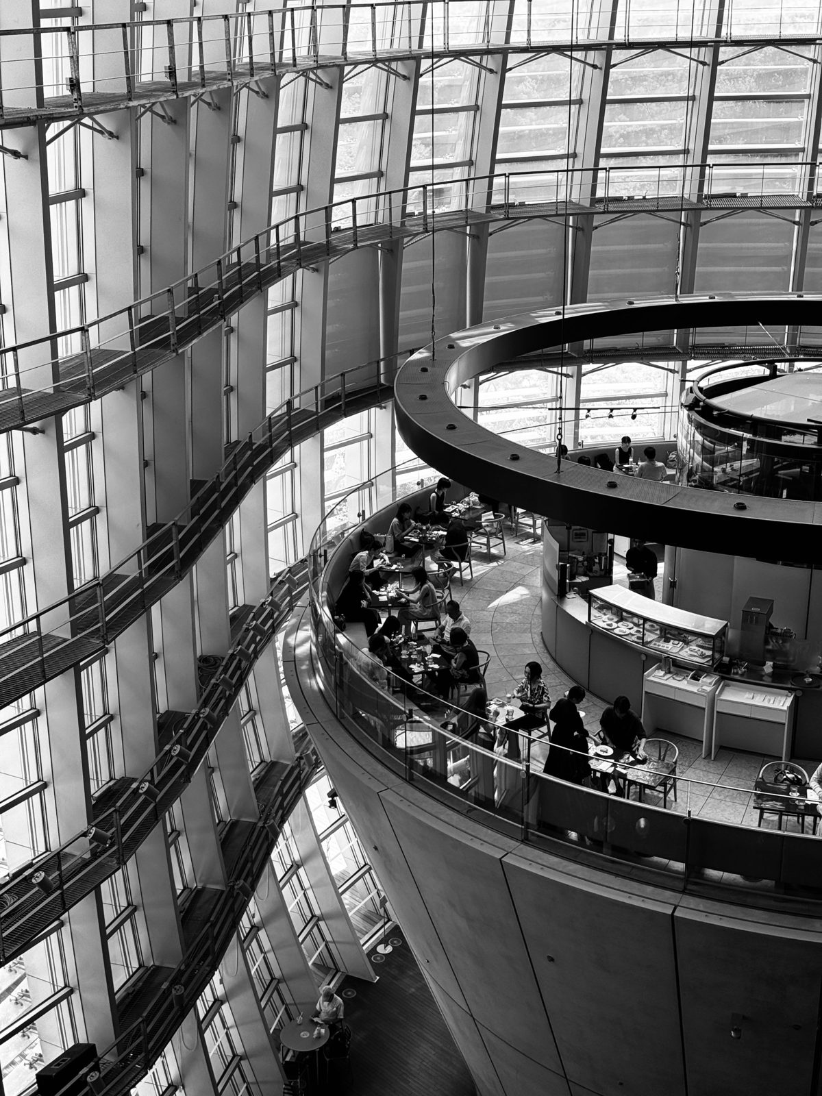 Café ring inside a curved glass atrium, black and white